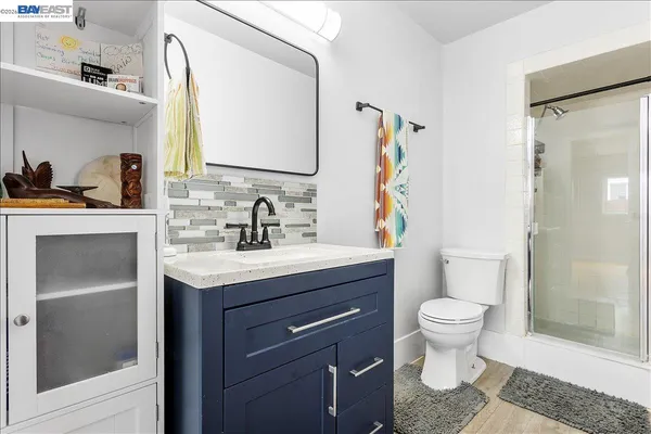 a bathroom with a tub sink and mirror