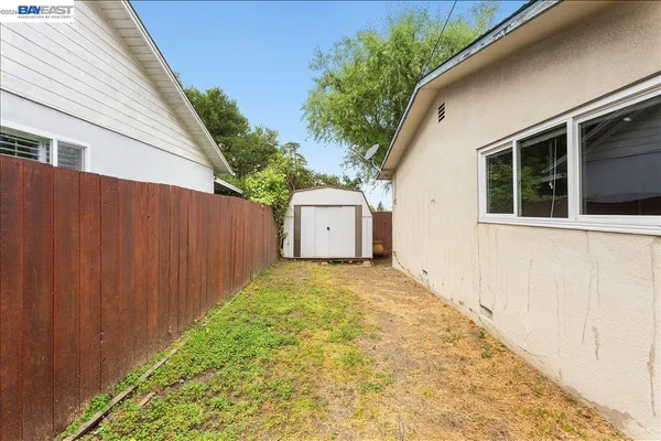 a view of a backyard with sitting area