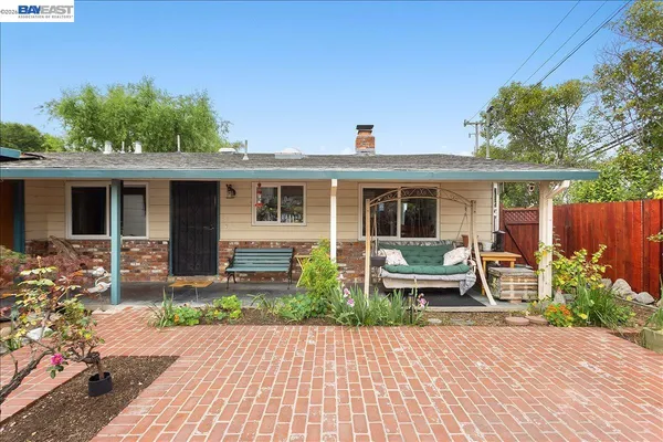 a view of a chairs and table in the patio