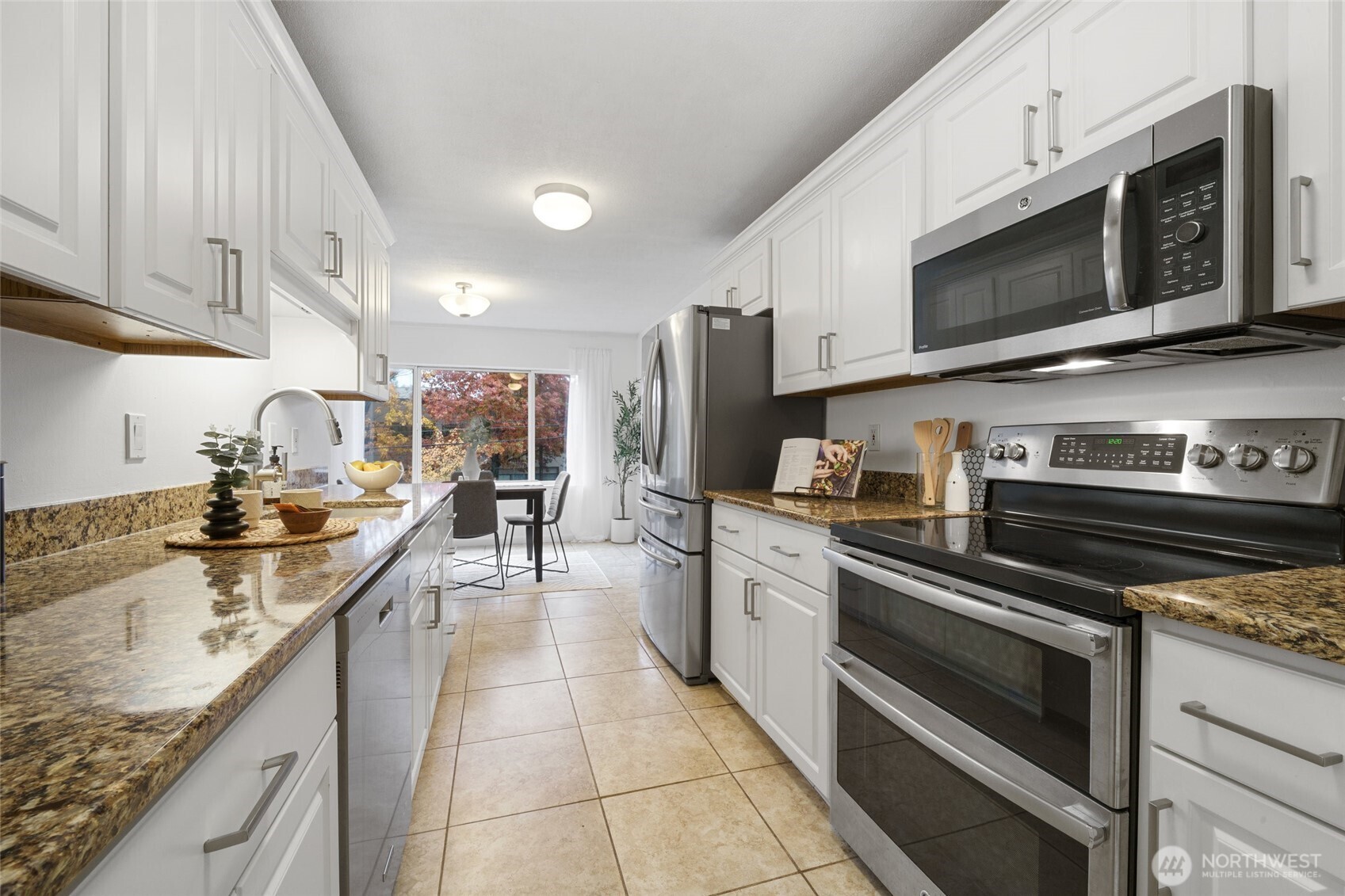 4545 Sand Point Way Northeast, Unit 203 Seattle, WA 98105 - Photo 13 of 28 a kitchen with stainless steel appliances granite countertop a sink and stove top oven
