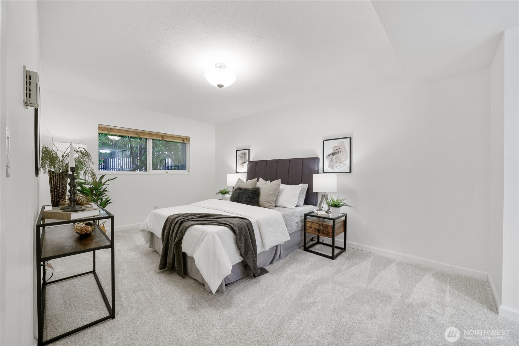 4545 Sand Point Way Northeast, Unit 203 Seattle, WA 98105 - Photo 19 of 28 a bedroom with a bed and wooden floor