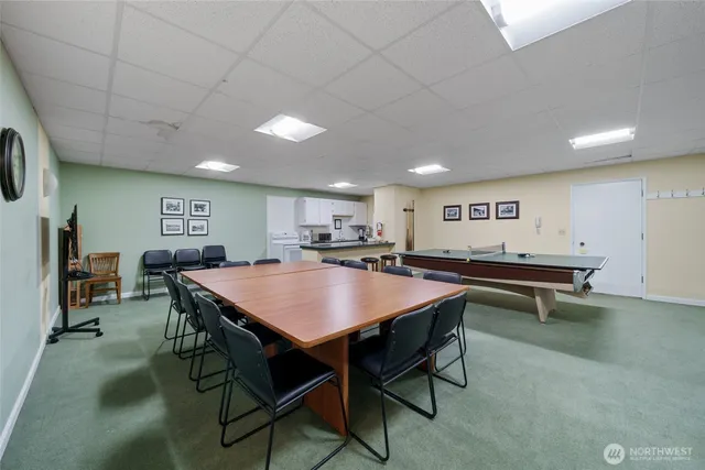 a room with furniture pool table and flat screen tv