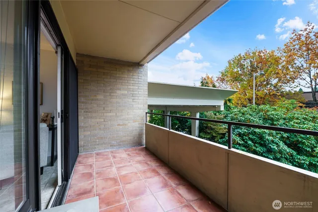 a view of balcony with wooden floor and outdoor seating