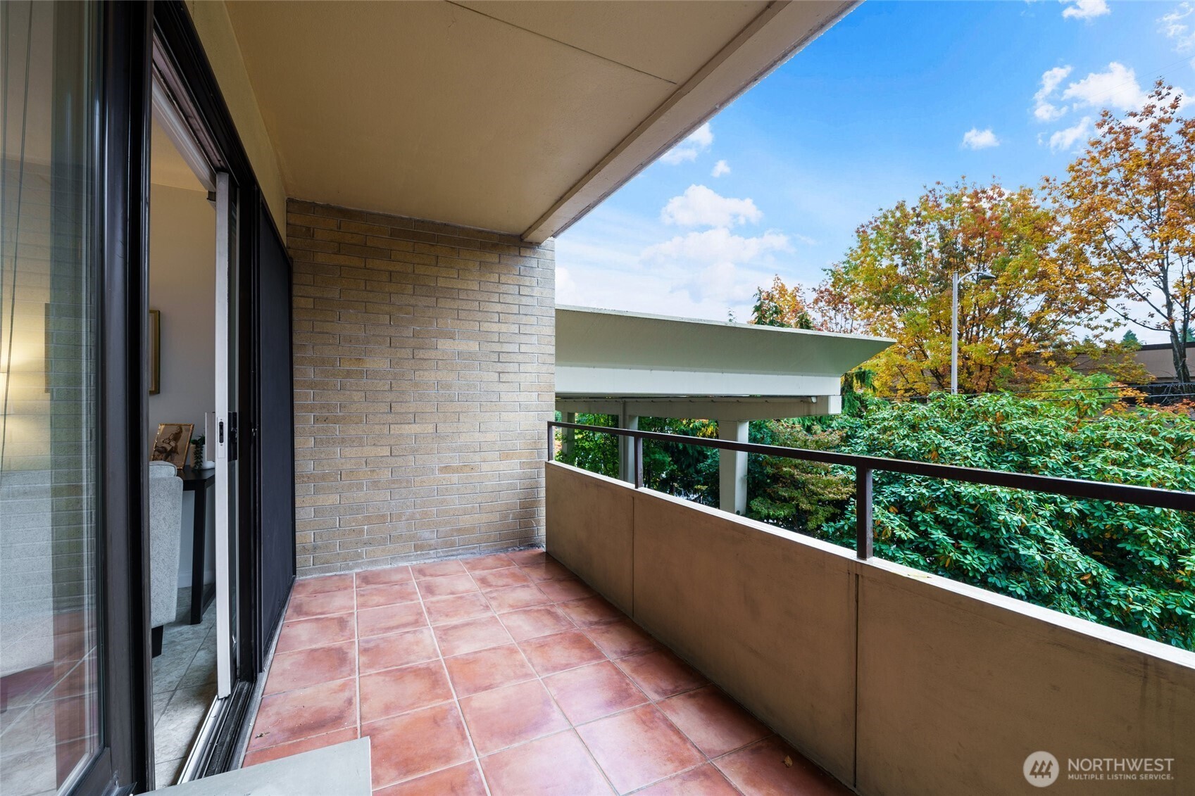 4545 Sand Point Way Northeast, Unit 203 Seattle, WA 98105 - Photo 4 of 28 a view of balcony with wooden floor and outdoor seating