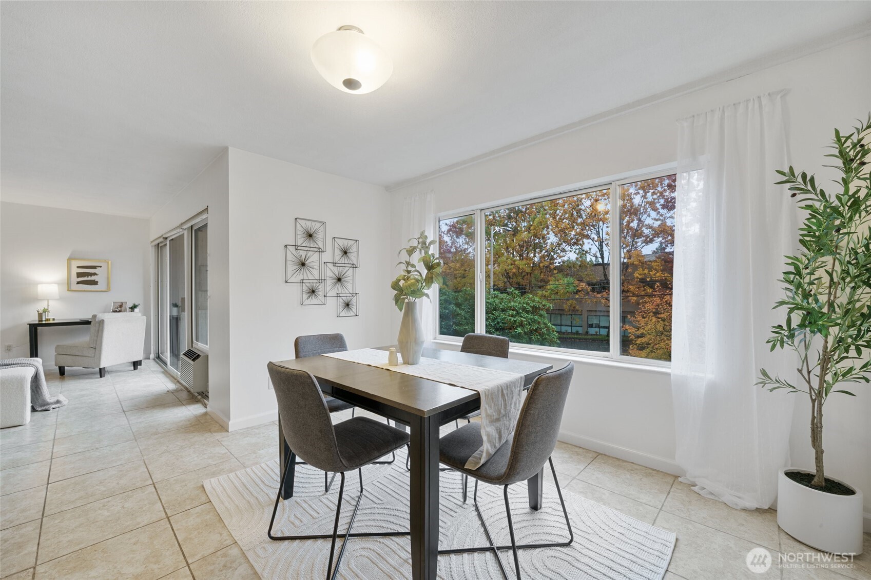 4545 Sand Point Way Northeast, Unit 203 Seattle, WA 98105 - Photo 10 of 28 a dining room with furniture and window