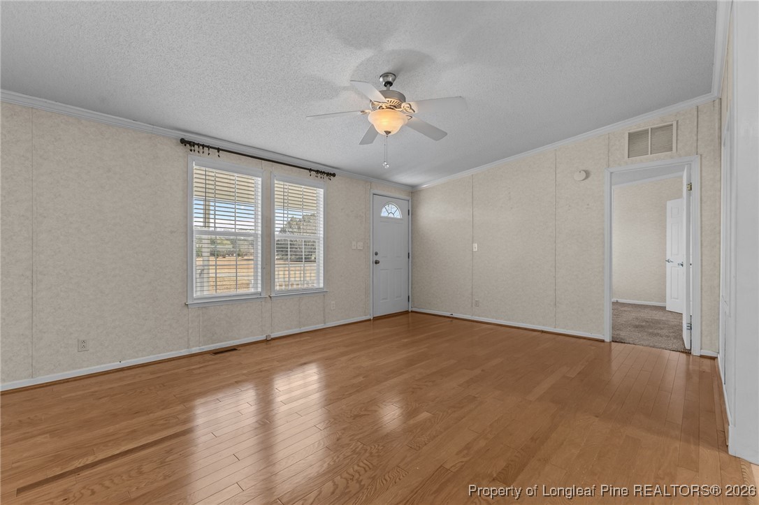 355 Rock Hill Road Fayetteville, NC 28312 - Photo 12 of 38 a view of empty room with wooden floor and fan