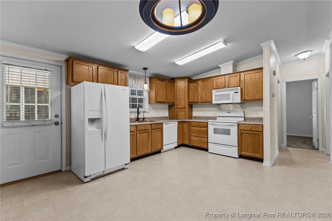 355 Rock Hill Road Fayetteville, NC 28312 - Photo 16 of 38 a kitchen with stainless steel appliances a refrigerator a sink a stove a microwave and island