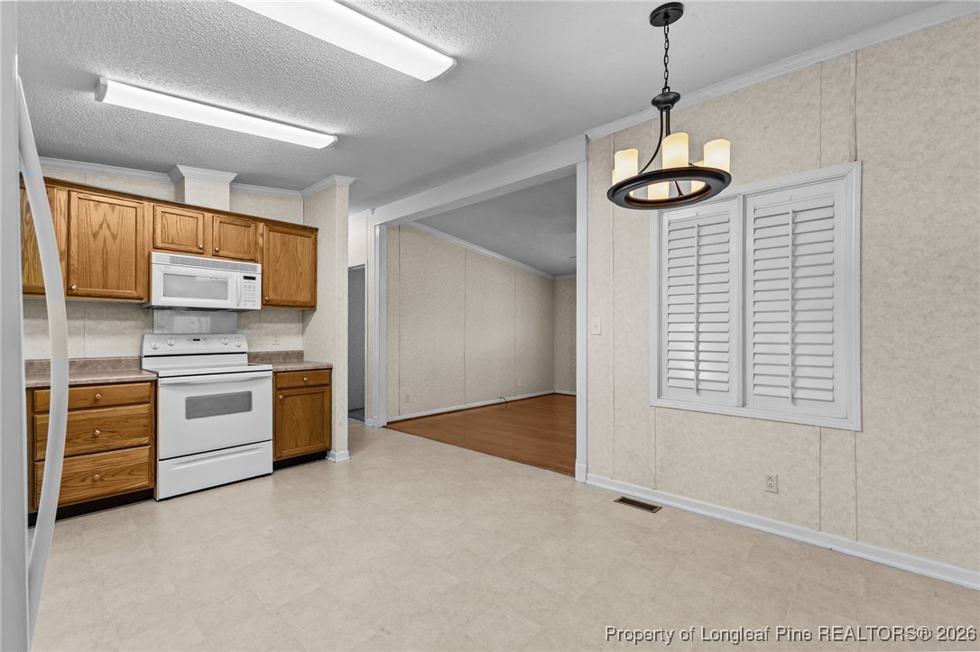 355 Rock Hill Road Fayetteville, NC 28312 - Photo 17 of 38 a view of a kitchen with stainless steel appliances granite countertop a stove and a refrigerator