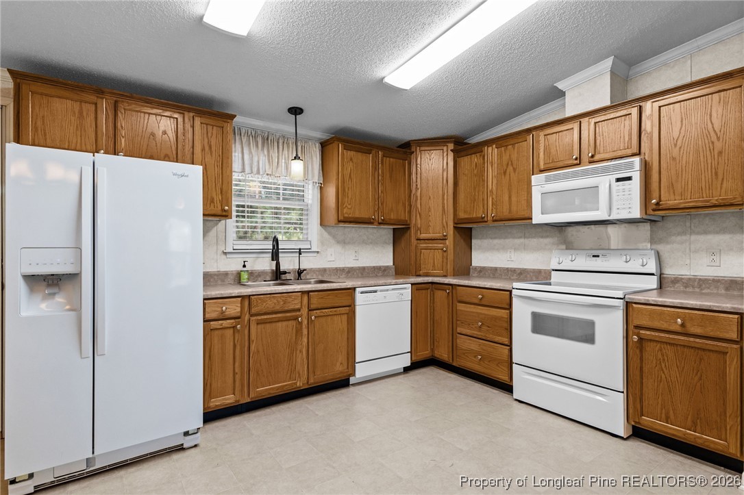 355 Rock Hill Road Fayetteville, NC 28312 - Photo 18 of 38 a kitchen with granite countertop cabinets stainless steel appliances and a sink