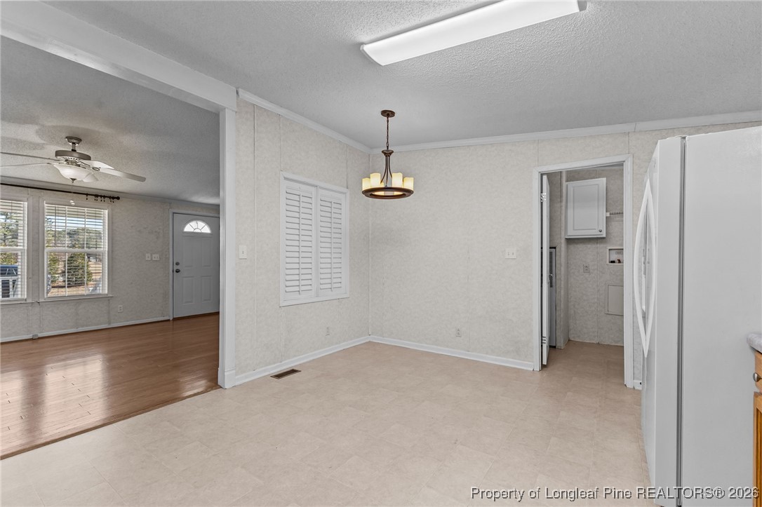 355 Rock Hill Road Fayetteville, NC 28312 - Photo 20 of 38 an empty room with chandelier fan and windows