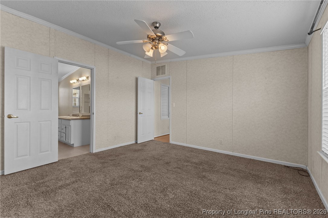 355 Rock Hill Road Fayetteville, NC 28312 - Photo 22 of 38 a view of an empty room with a chandelier fan
