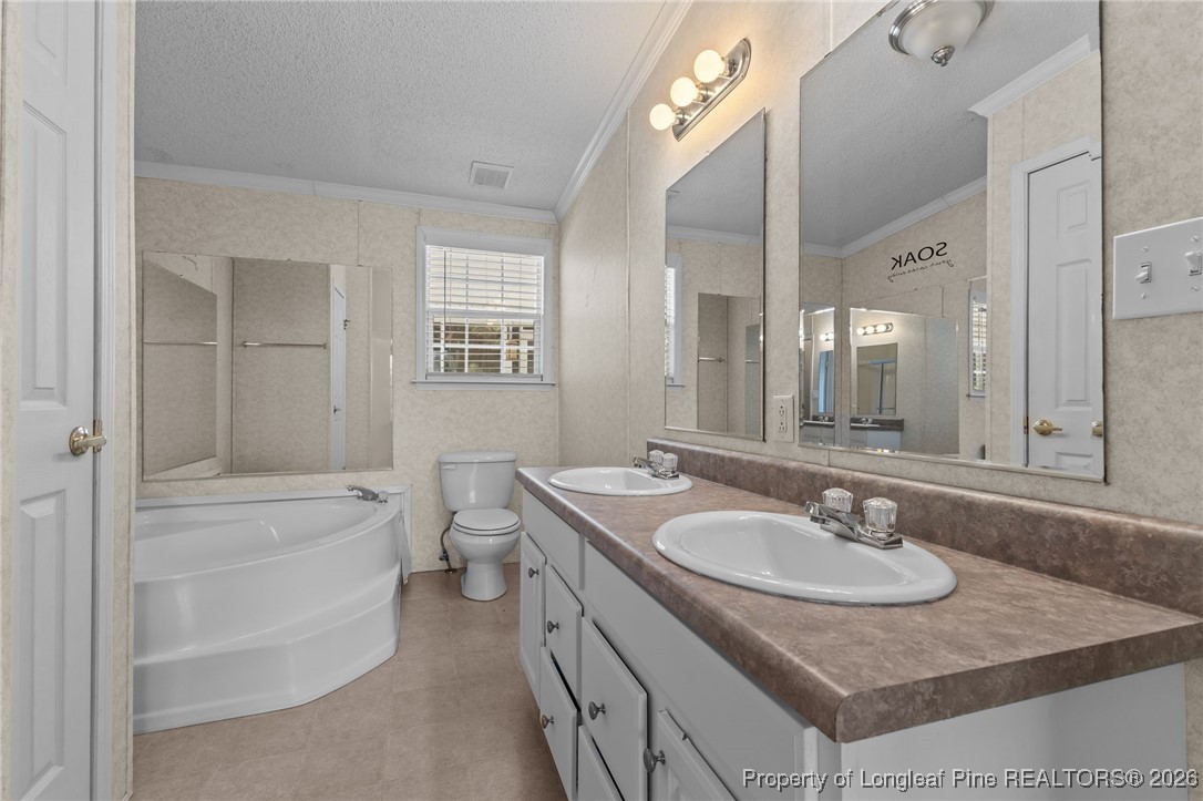 355 Rock Hill Road Fayetteville, NC 28312 - Photo 24 of 38 a bathroom with a sink double vanity granite tub shower and a mirror