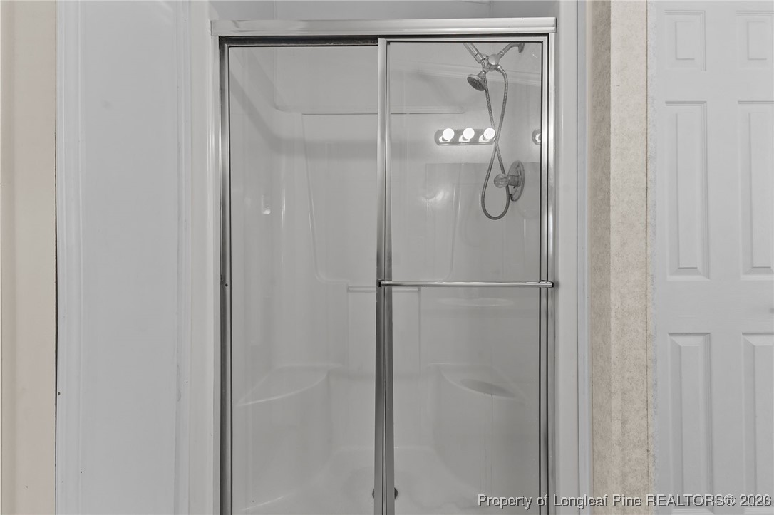 355 Rock Hill Road Fayetteville, NC 28312 - Photo 26 of 38 a bathroom with a glass shower door