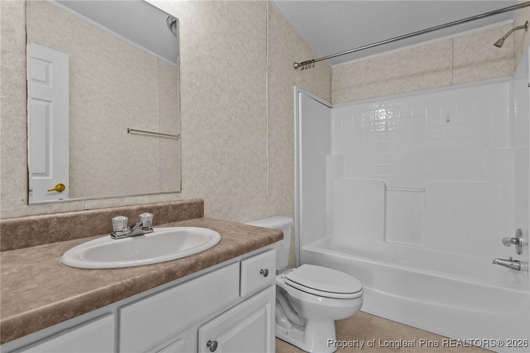 355 Rock Hill Road Fayetteville, NC 28312 - Photo 32 of 38 a bathroom with a granite countertop sink toilet and shower