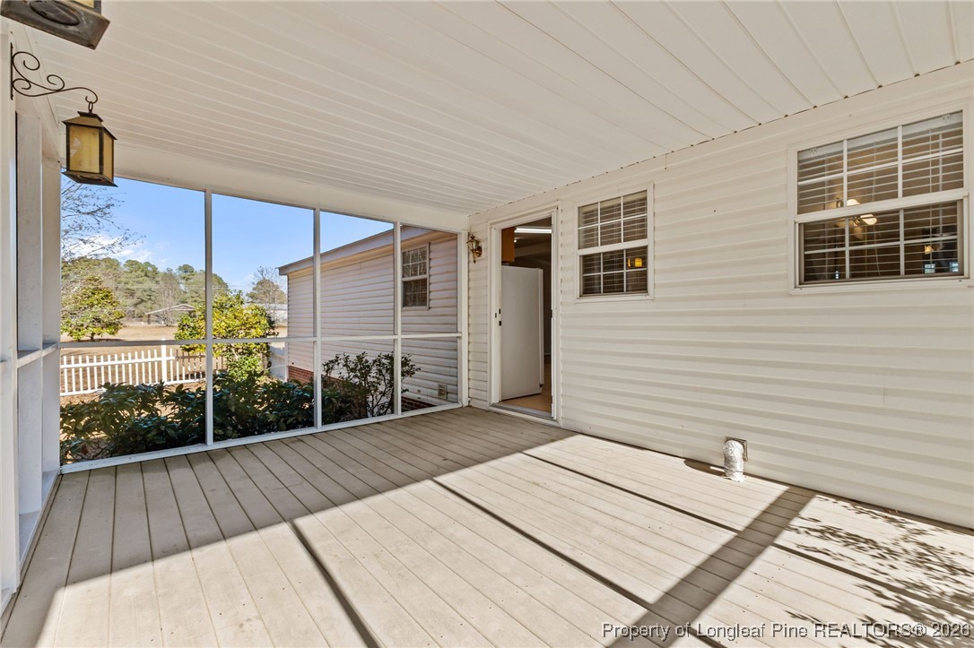 355 Rock Hill Road Fayetteville, NC 28312 - Photo 8 of 38 a view of a balcony with wooden floor and fence