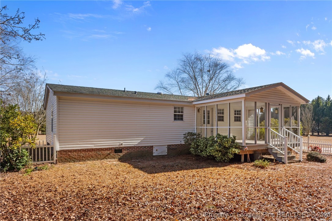 355 Rock Hill Road Fayetteville, NC 28312 - Photo 9 of 38 a front view of a house with a yard and potted plants