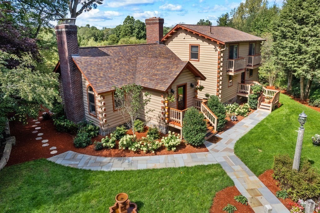 a aerial view of a house with a yard patio and fire pit