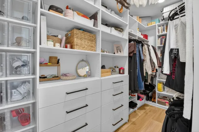 a bedroom with furniture and a flat screen tv