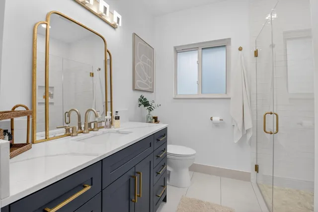 a bathroom with a double vanity sink mirror and bathtub