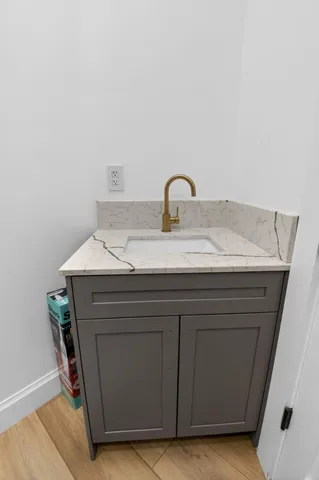 a bathroom with a tub shower sink and mirror