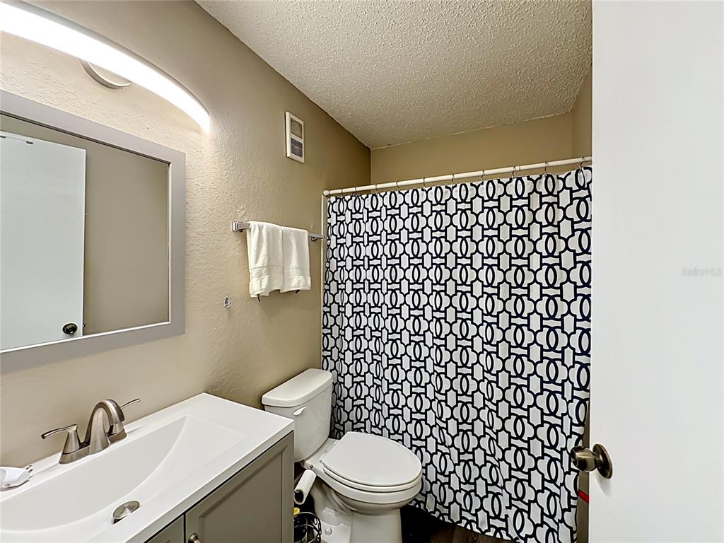 3705 Southwest 27th Street, Unit 922 Gainesville, FL 32608 - Photo 21 of 34 a bathroom with a sink a toilet and a shower