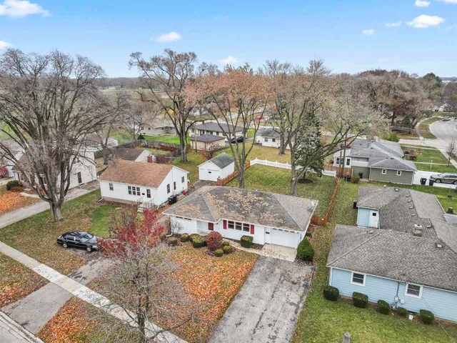 a aerial view of a house with a mountain in the background