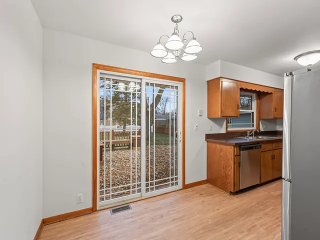 a view of a kitchen with stainless steel appliances granite countertop a sink and cabinets