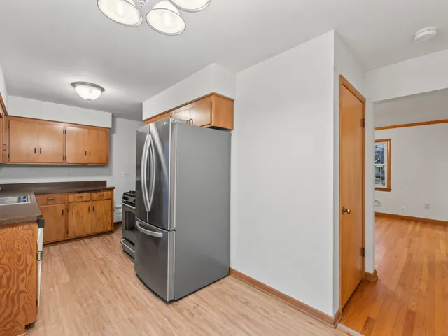 a kitchen with stainless steel appliances granite countertop a refrigerator and a stove top oven