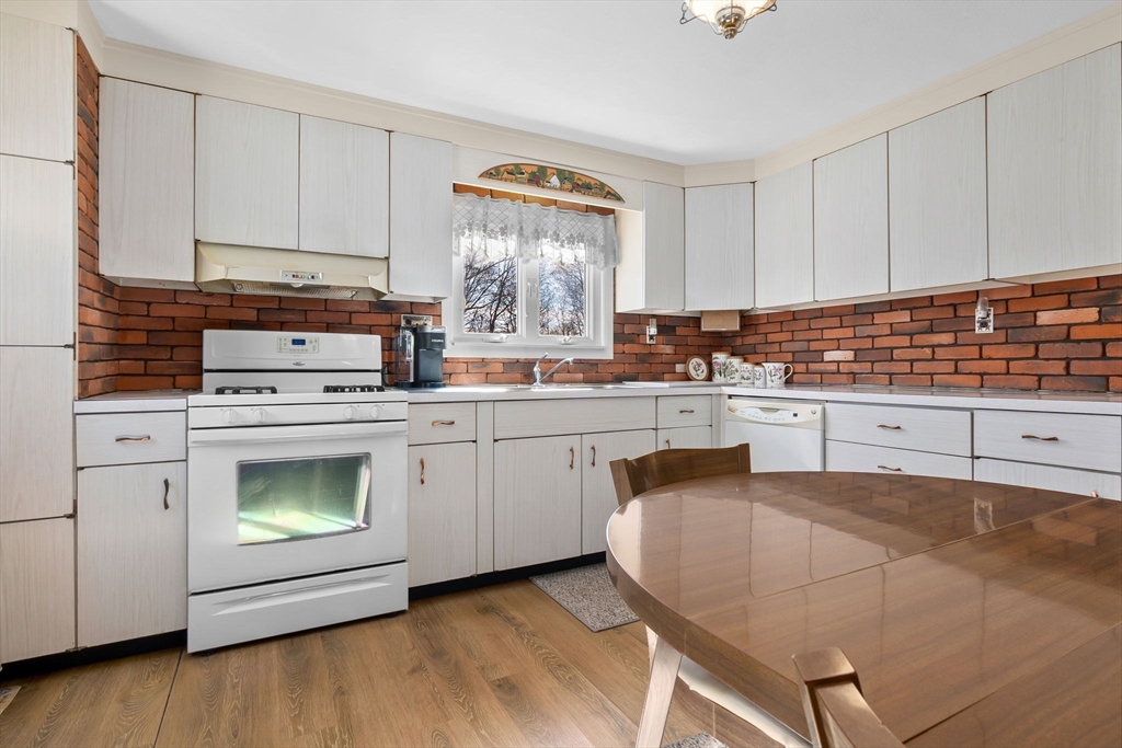 1 Robert Road Danvers, MA 01923 - Photo 8 of 39 a kitchen with a stove sink and cabinets