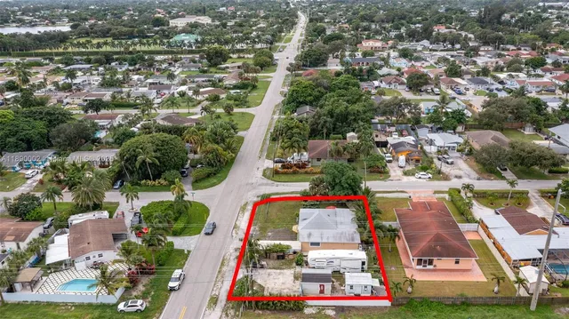 an aerial view of residential houses with outdoor space and swimming pool