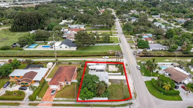 an aerial view of residential houses with outdoor space and swimming pool