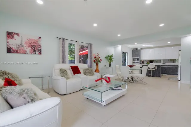 a living room with furniture and kitchen view