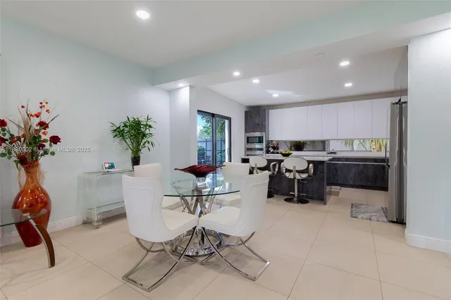 a living room with furniture gym equipment and potted plants