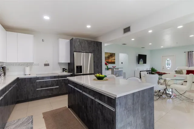 a kitchen with a stove sink and cabinets
