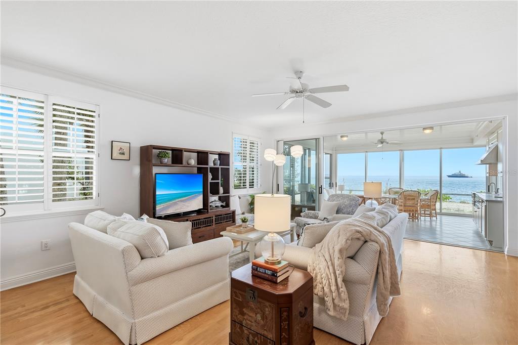 831 Harborshore Drive, Unit 1 Boca Grande, FL 33921 - Photo 14 of 81 a living room with furniture a flat screen tv and a large window