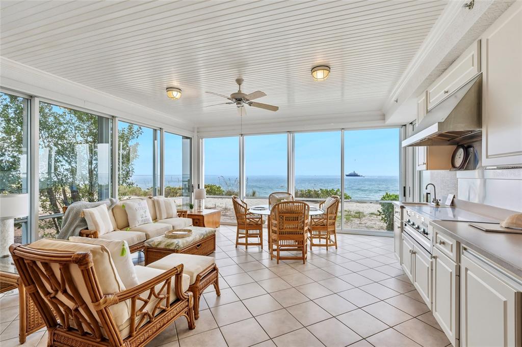 831 Harborshore Drive, Unit 1 Boca Grande, FL 33921 - Photo 18 of 81 a living room with furniture a large window and a table