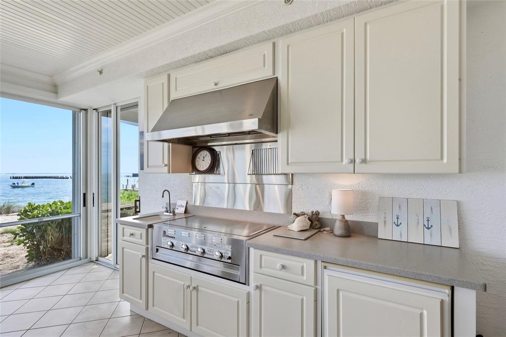831 Harborshore Drive, Unit 1 Boca Grande, FL 33921 - Photo 20 of 81 a kitchen with stainless steel appliances granite countertop a sink a stove and a white cabinets