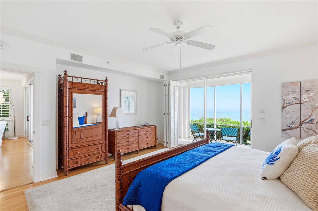 831 Harborshore Drive, Unit 1 Boca Grande, FL 33921 - Photo 23 of 81 a bedroom with a bed and a chandelier