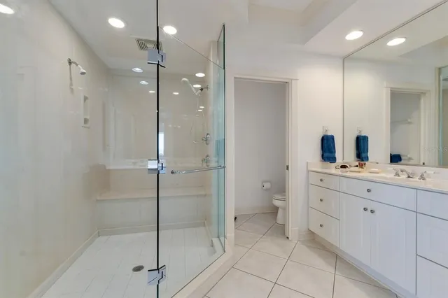 a living room with couches a dining table and chairs with wooden floor