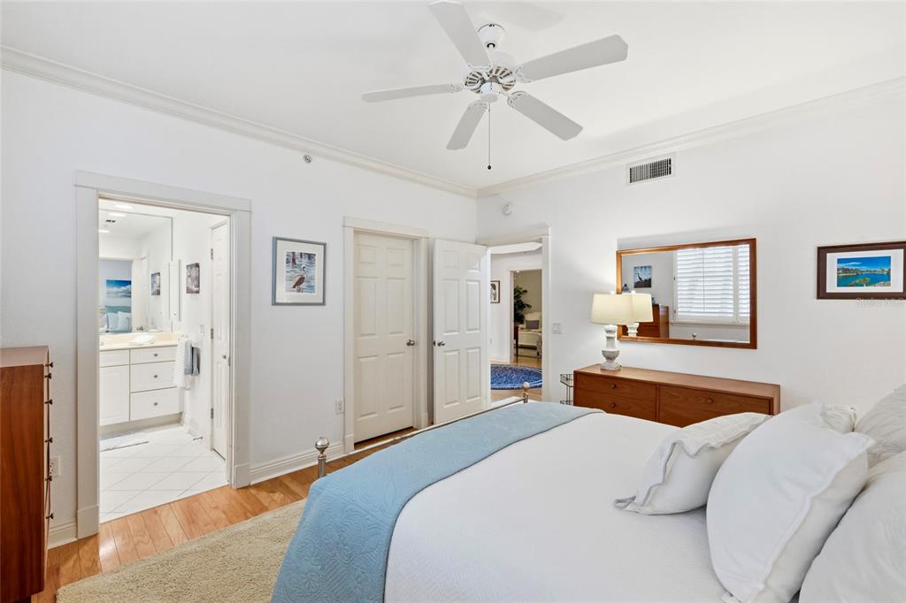 831 Harborshore Drive, Unit 1 Boca Grande, FL 33921 - Photo 30 of 81 a bedroom with a bed and a chandelier