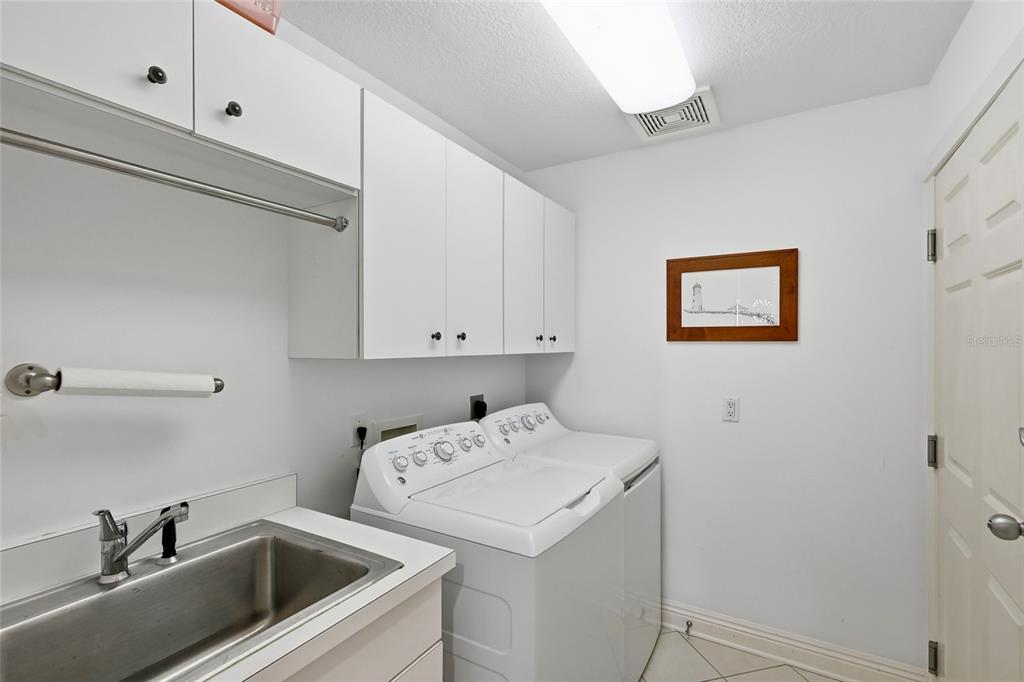 831 Harborshore Drive, Unit 1 Boca Grande, FL 33921 - Photo 32 of 81 a utility room with dryer and washer
