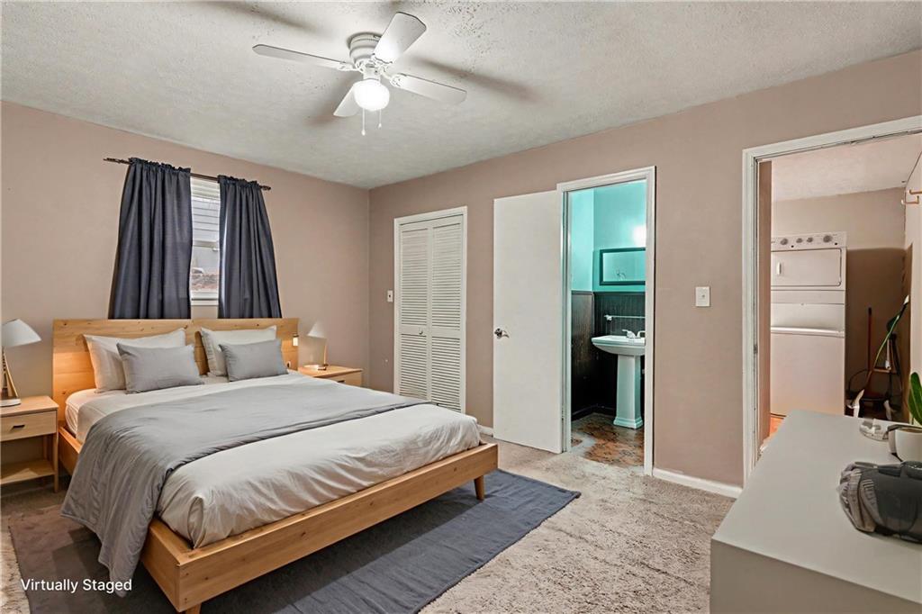 1995 Matt Drive Austell, GA 30168 - Photo 18 of 34 a bedroom with a bed and a chandelier with a flat tv screen