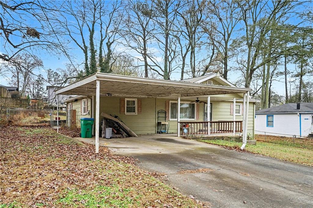 1995 Matt Drive Austell, GA 30168 - Photo 4 of 34 a view of a house with a large tree and wooden fence