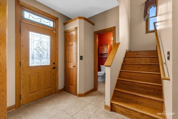 a view of entryway with wooden floor and stair