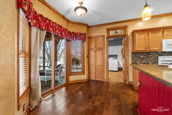 a kitchen with stainless steel appliances granite countertop a sink stove and cabinets