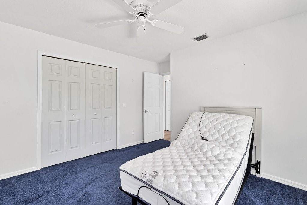 738 Benedictine Terrace Sebastian, FL 32958 - Photo 17 of 33 a room with a bed and wooden floor