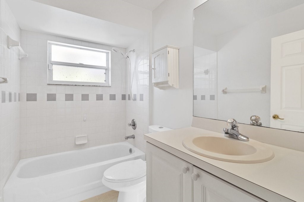 738 Benedictine Terrace Sebastian, FL 32958 - Photo 18 of 33 a bathroom with a sink toilet tub and shower