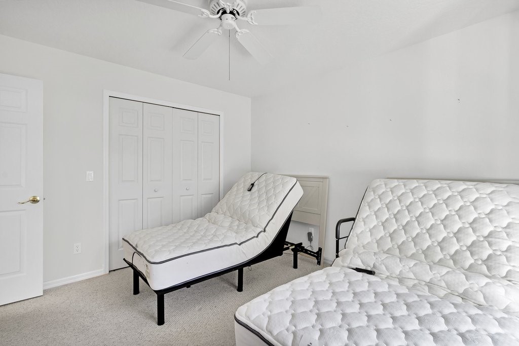 738 Benedictine Terrace Sebastian, FL 32958 - Photo 20 of 33 a bedroom with a bed and a chair