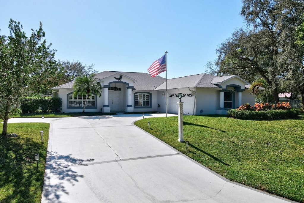 738 Benedictine Terrace Sebastian, FL 32958 - Photo 2 of 33 a front view of a house with a yard