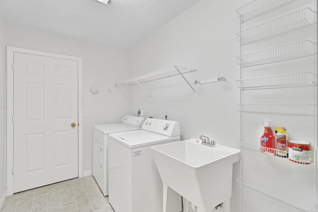 738 Benedictine Terrace Sebastian, FL 32958 - Photo 21 of 33 a utility room with sink dryer and washer